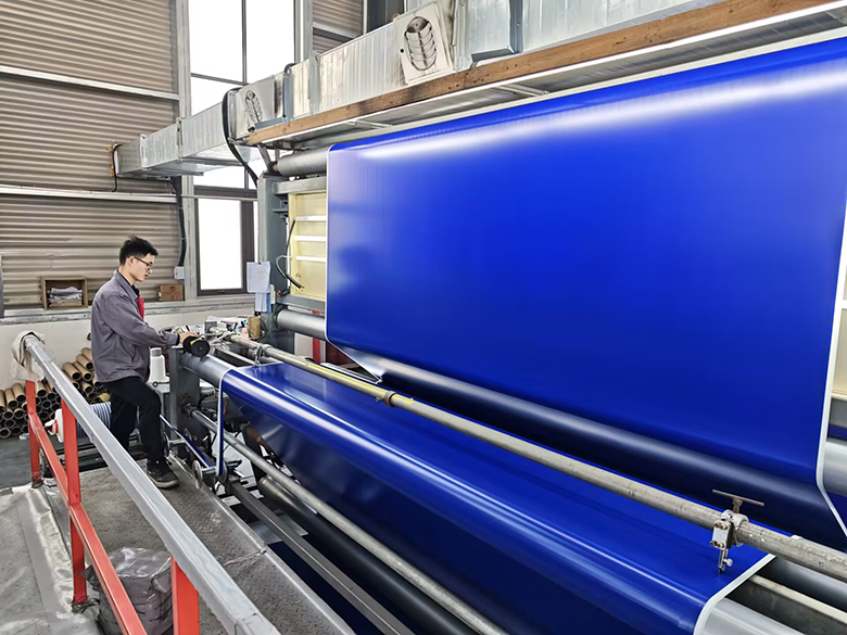 DERFLEX factory line processing a wide blue PVC coated textile roll
