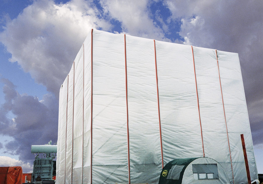 Temporary building enclosure tarp covering an industrial structure