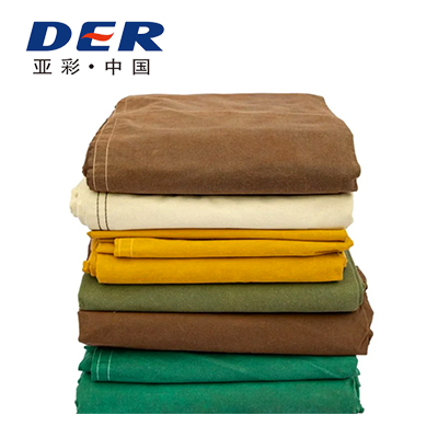 Stack of folded canvas fabrics in brown, cream, yellow, olive and green on the DERFLEX website