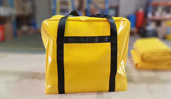Yellow coated-fabric carry bag with black webbing handles and reinforcement