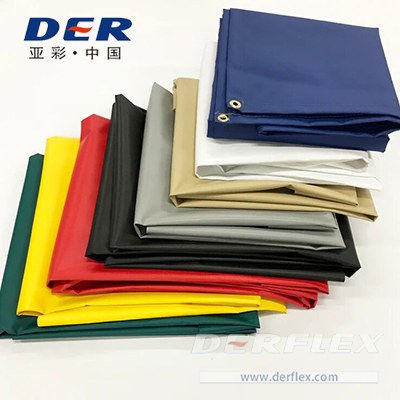 Folded DERFLEX finished tarps in several colors, with eyelets visible on the top cover