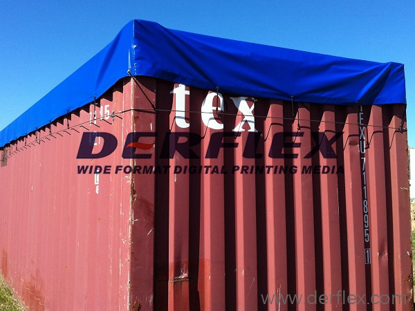 Blue cover over a shipping container showing the side drop and corner profile