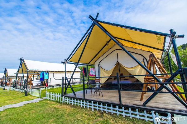 Safari-style glamping accommodation with a separate yellow outer roof canopy and enclosed inner tent