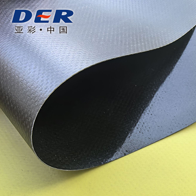 Grey coated fabric folded back to show its textured surface and dark underside