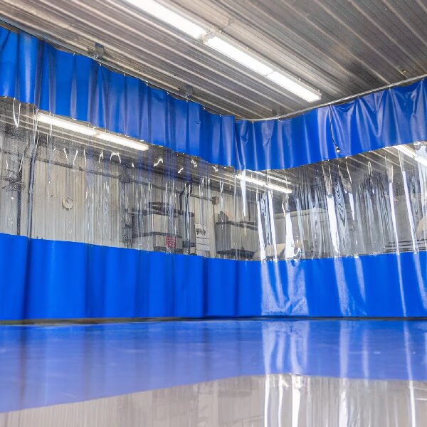 Blue industrial curtain enclosure with a clear viewing band and overhead hanging points