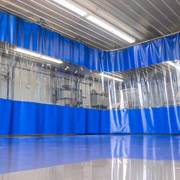 Blue industrial divider curtain with a clear viewing band and overhead suspension