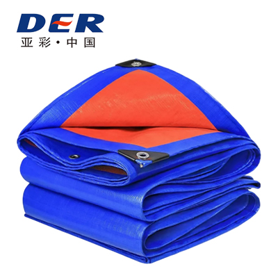 Blue tarp folded to show an orange reverse face, corner patches and metal eyelets in the DERFLEX PE tarp catalog