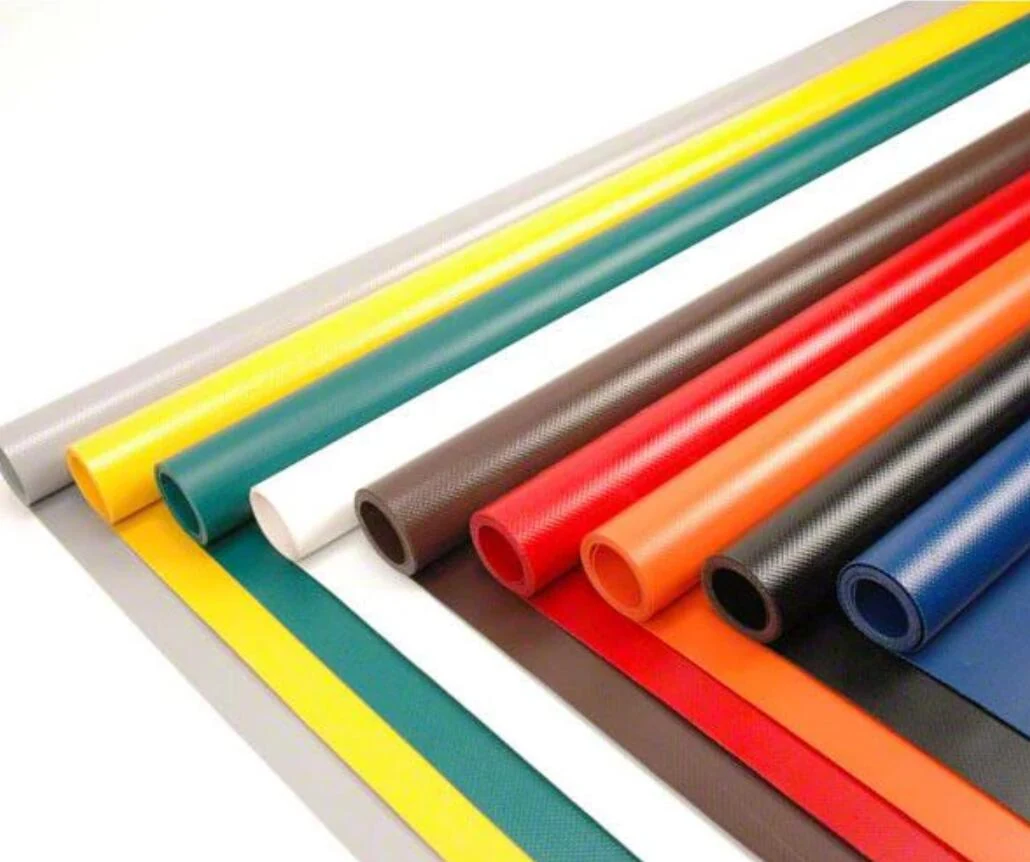 Colored PVC coated fabric sheets with rolled edges showing a range of surface colors