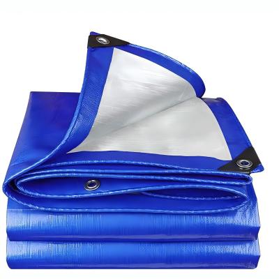 Blue finished tarp folded to show its edge reinforcement and metal eyelets