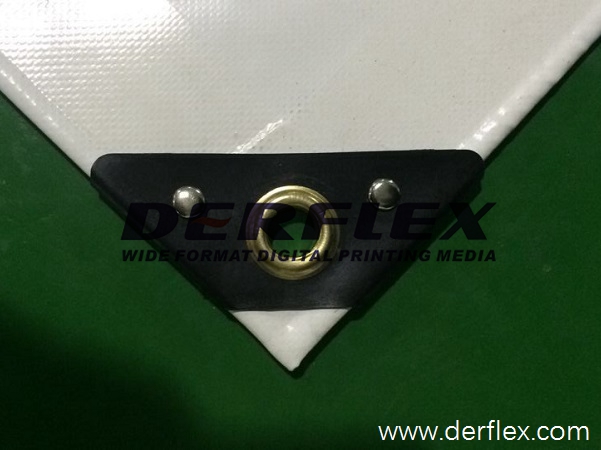 White tarp corner with a black triangular reinforcement plate and metal eyelet