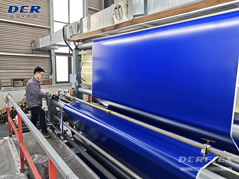 Blue coated textile passing through production equipment