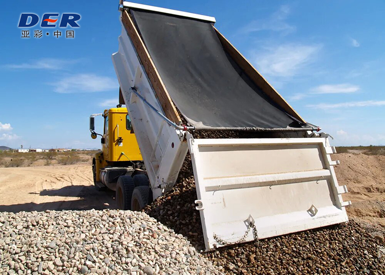 DER-branded tarp on a raised dump body during unloading